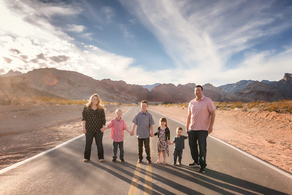 Family of 6 in Joshua Tree taking a family portrait with traveling photographer, Emily Winnie