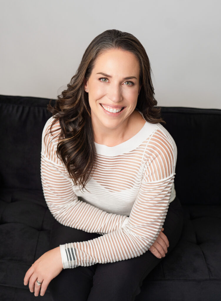 Branding session with a woman in a white shirt sitting on a dark couch in Culver City.