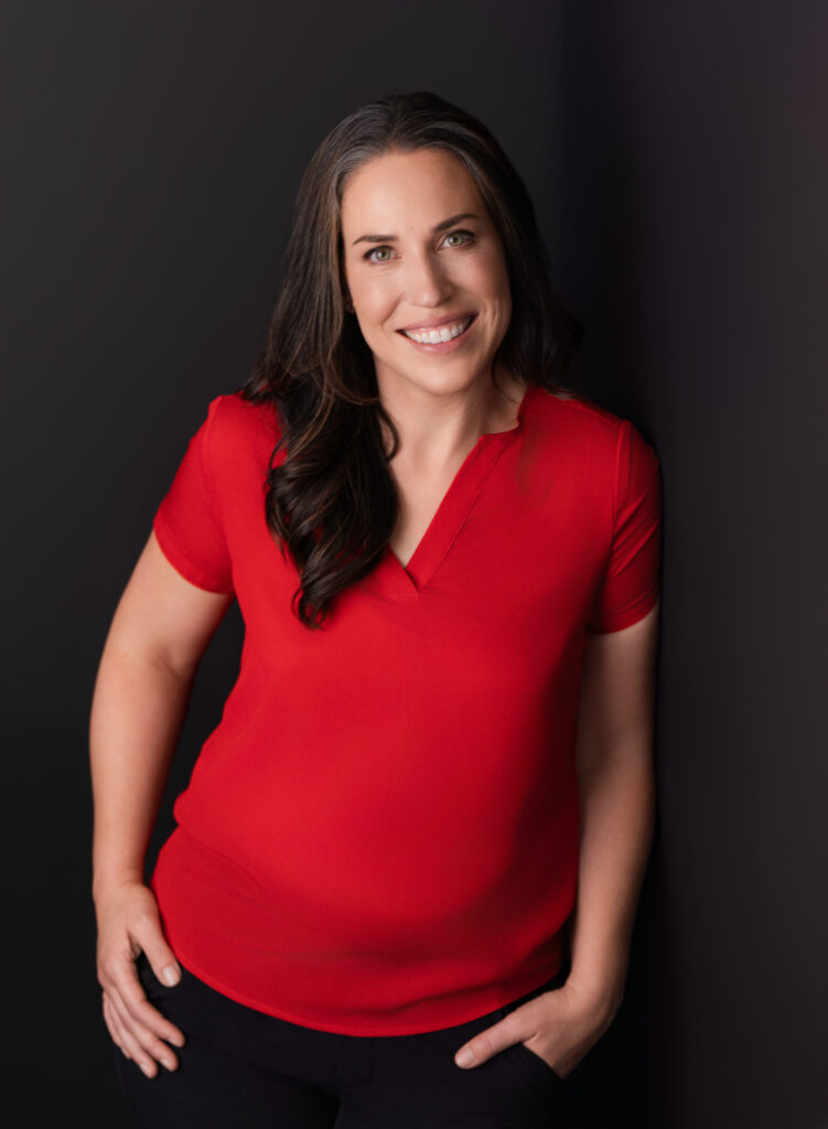 Branding session with a woman in a red shirt against a dark background in Culver City.