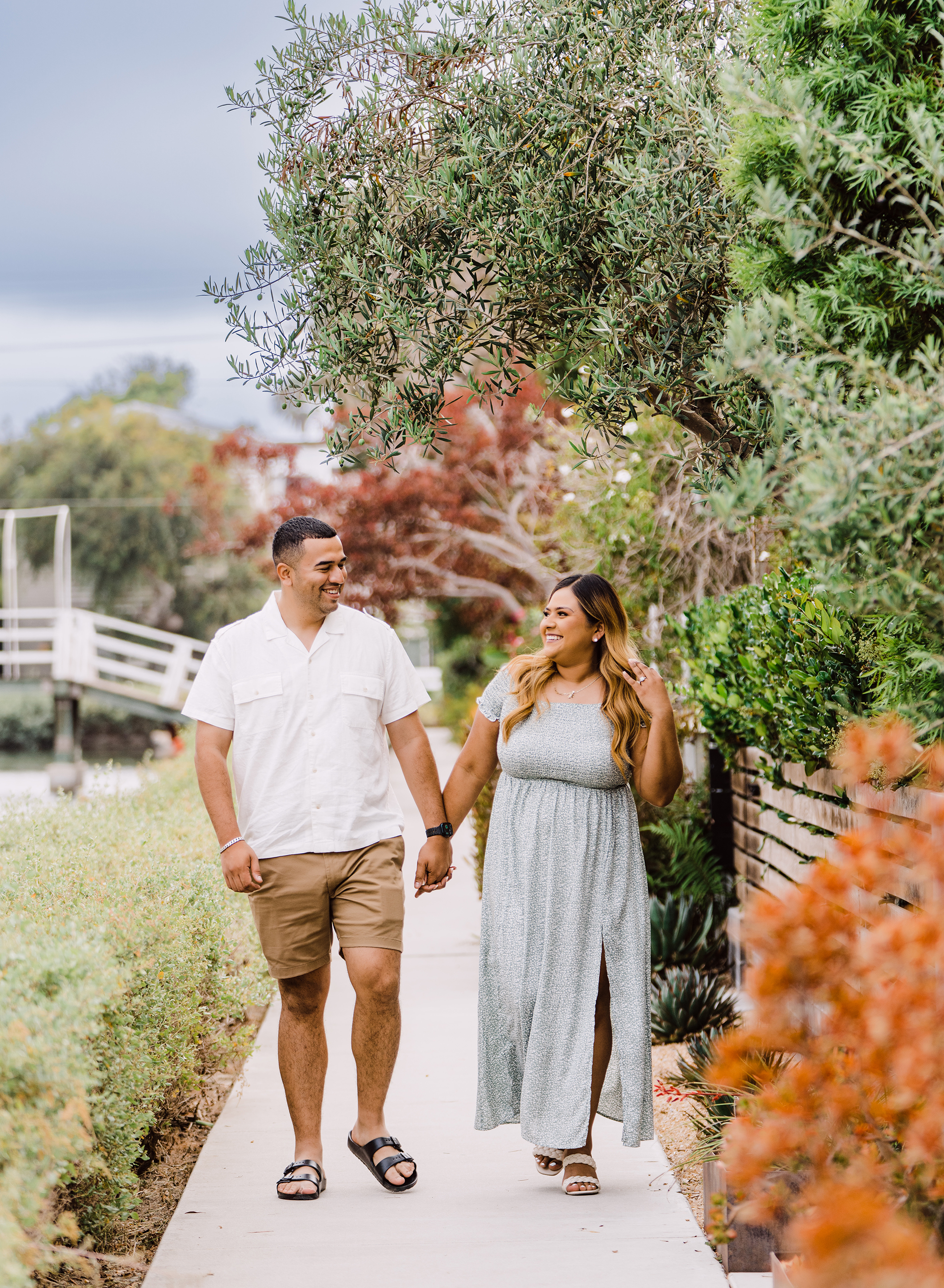A middle-aged couple at an engagement photo location at the Venice Canals with Emily Winnie Photography.