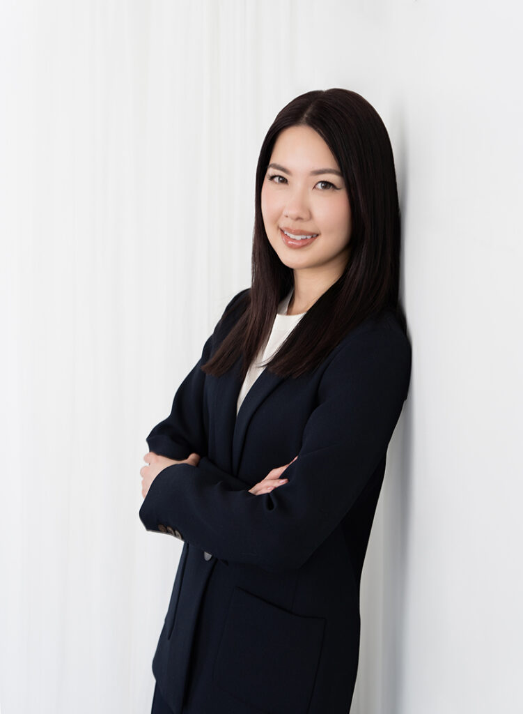 Headshots of a young female in a black jacket against a white wall with Emily Winnie Photography.